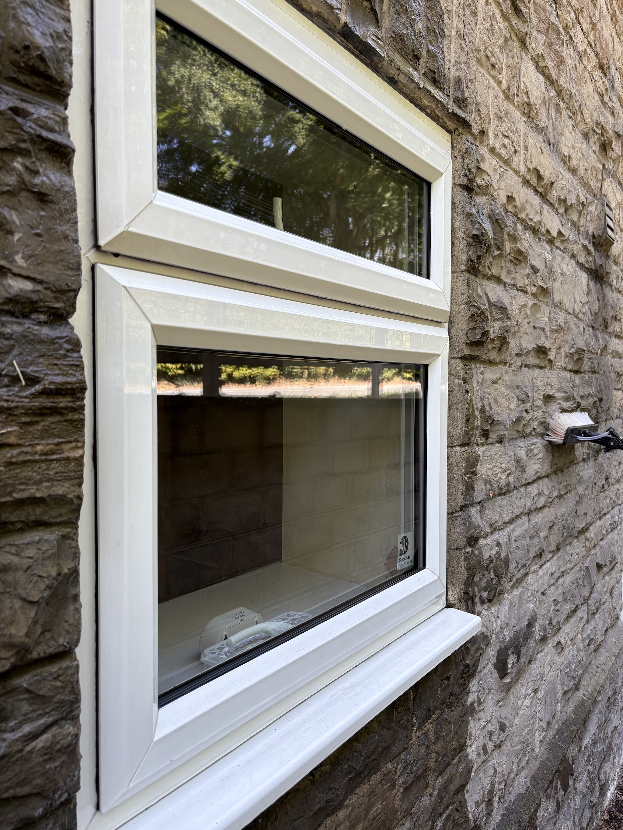 Spotless white uPVC windows set in a stone wall