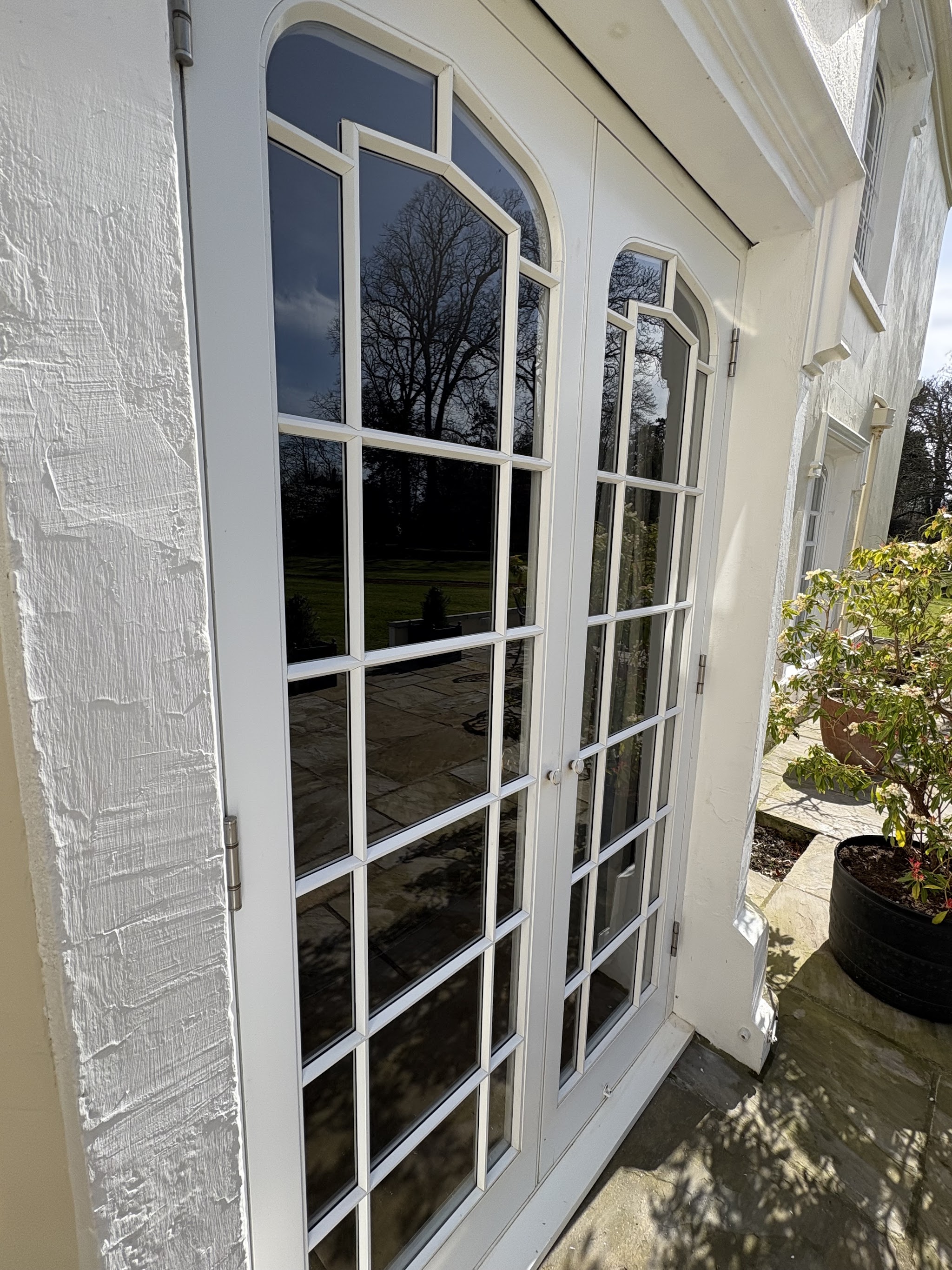 White French doors with Georgian bars, glass gleaming after a clean